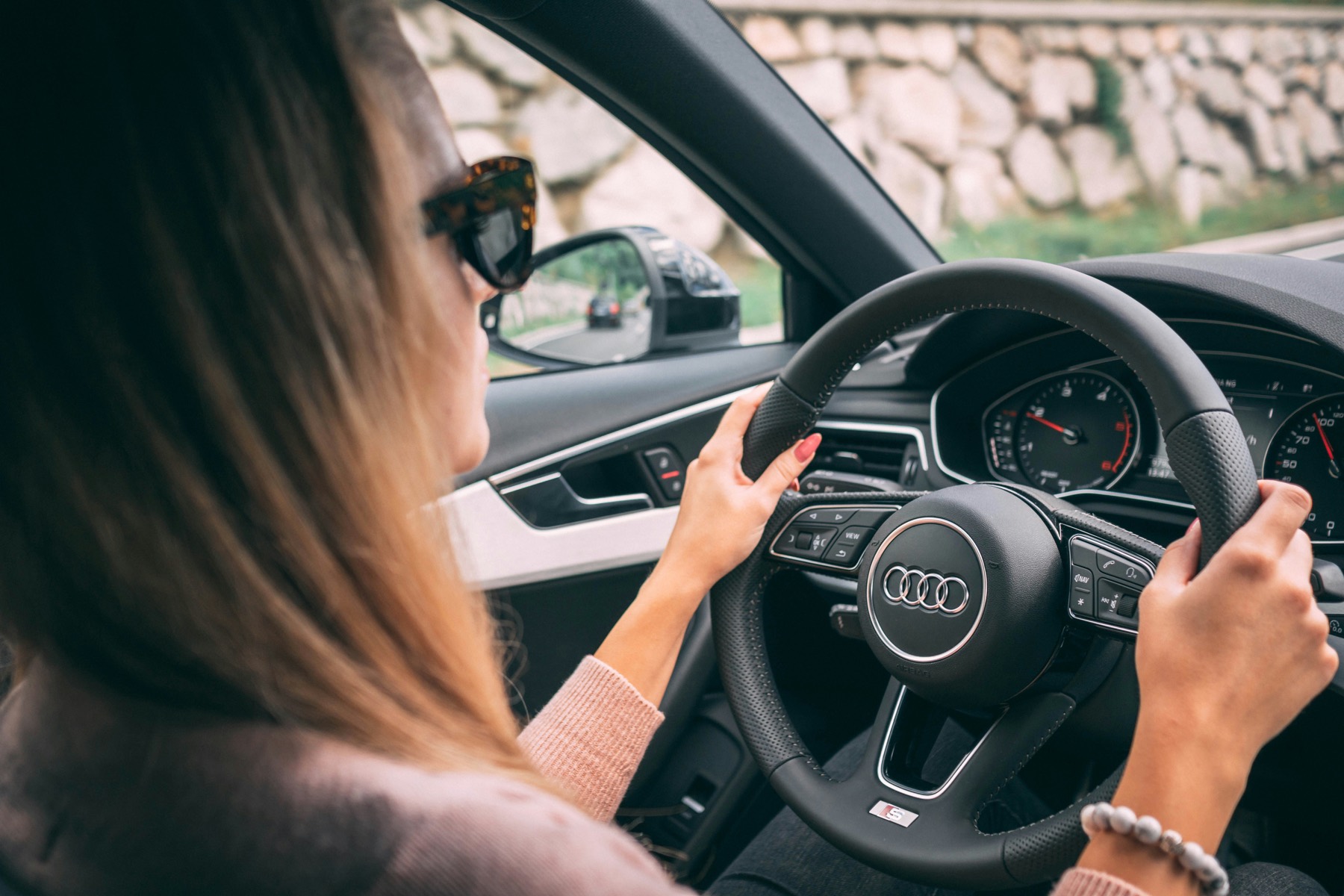 A driver in full control at the wheel on a Manchester road